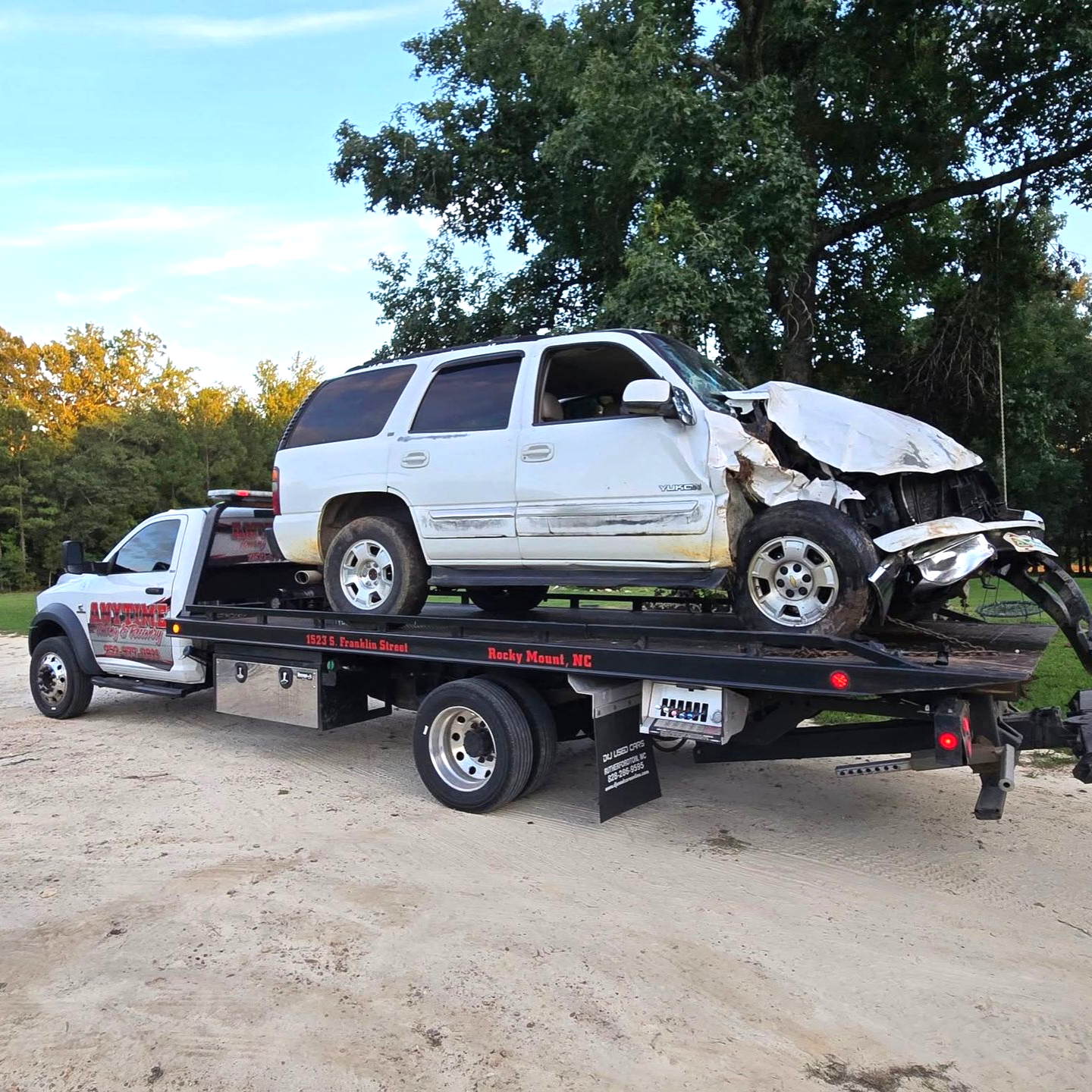White Roto-Rooter plumbing van on a tow truck, ladder on top in Rocky Mount, NC.