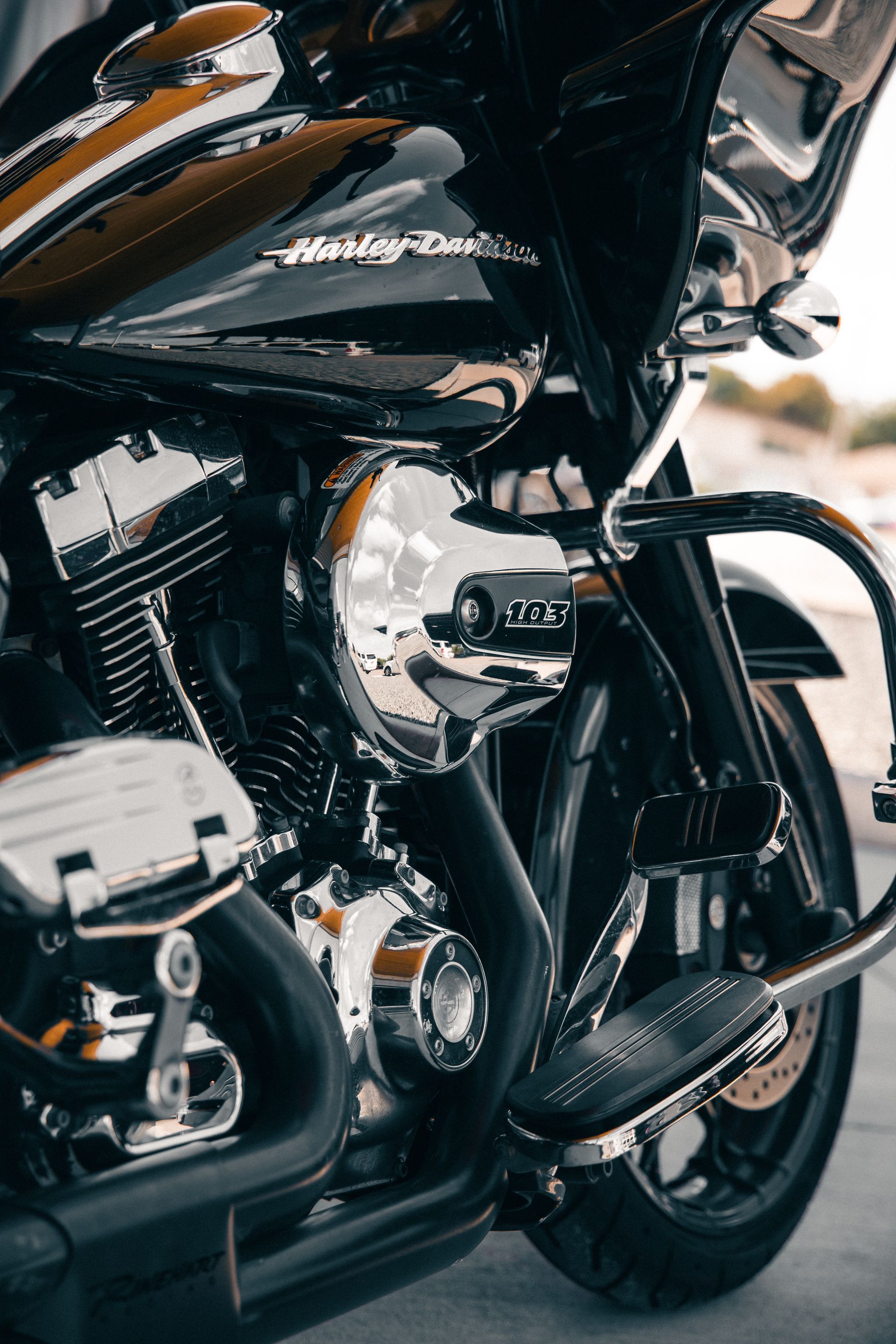 Black cruiser motorcycle with chrome engine and custom front wheel parked outdoors