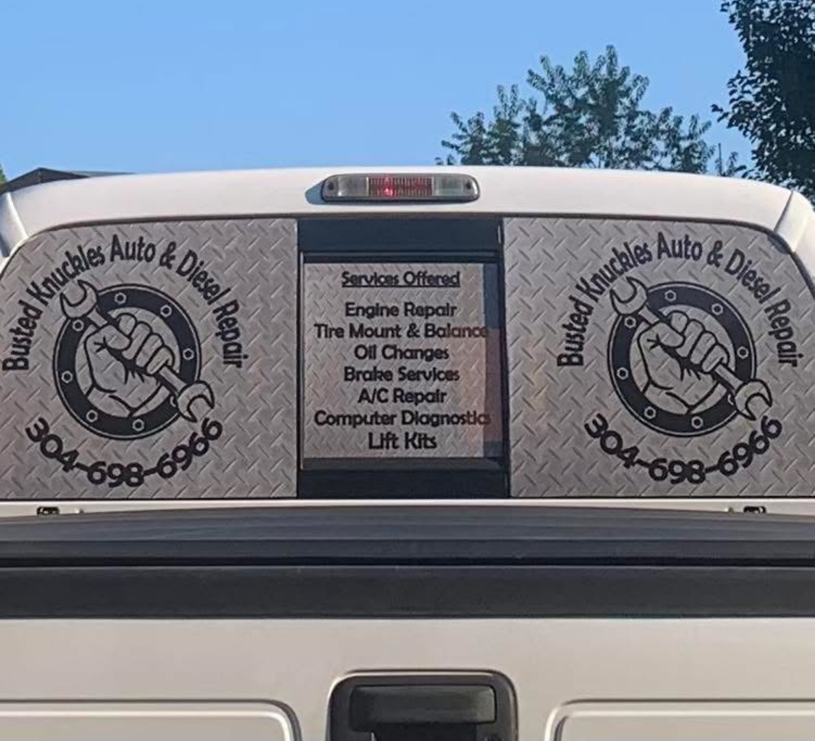 White van rear with “Wurble’s Auto & Diesel Repair” logos and service list on back doors.