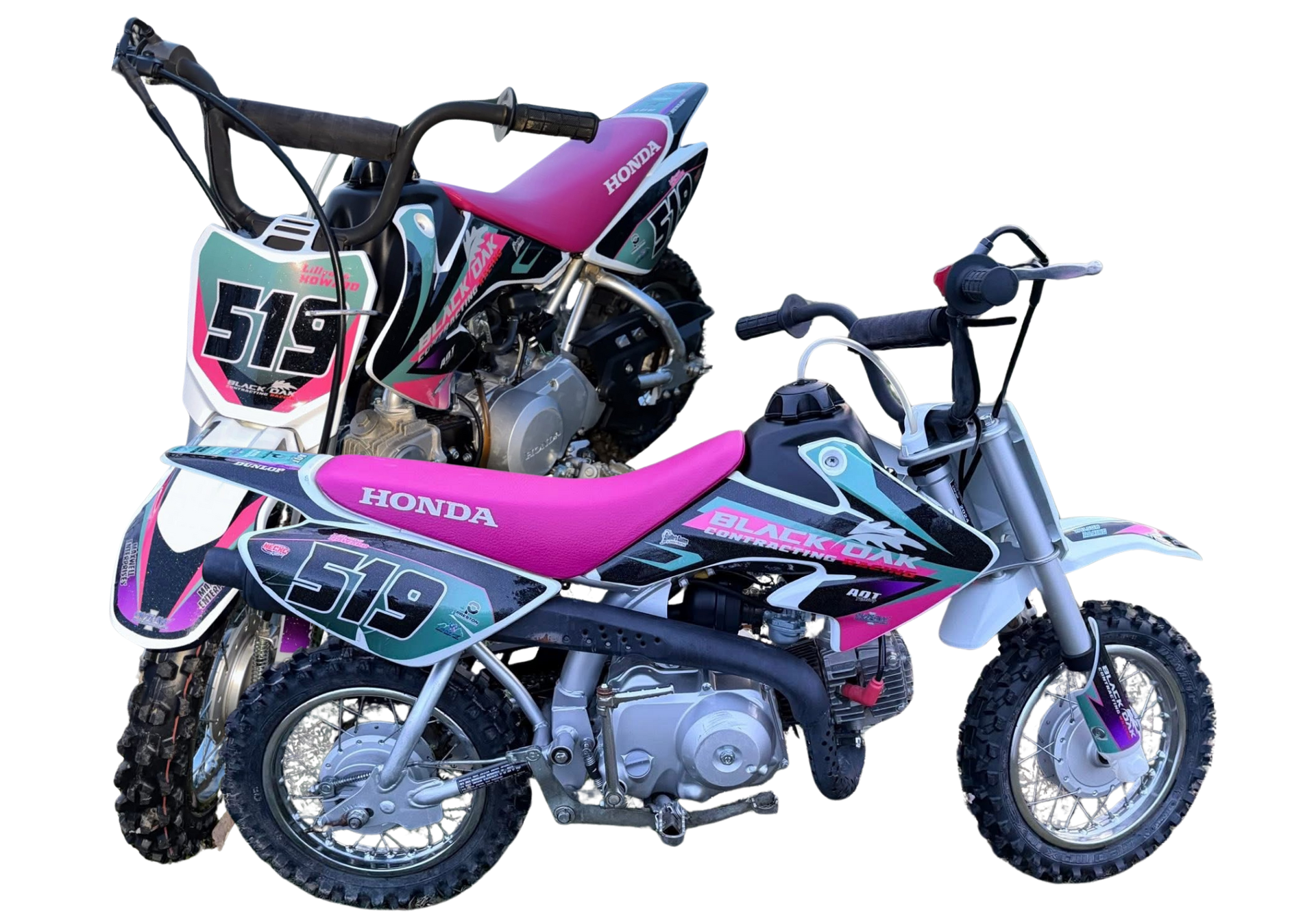 Two small pink and black racing minibikes, one stacked above the other, on a white background
