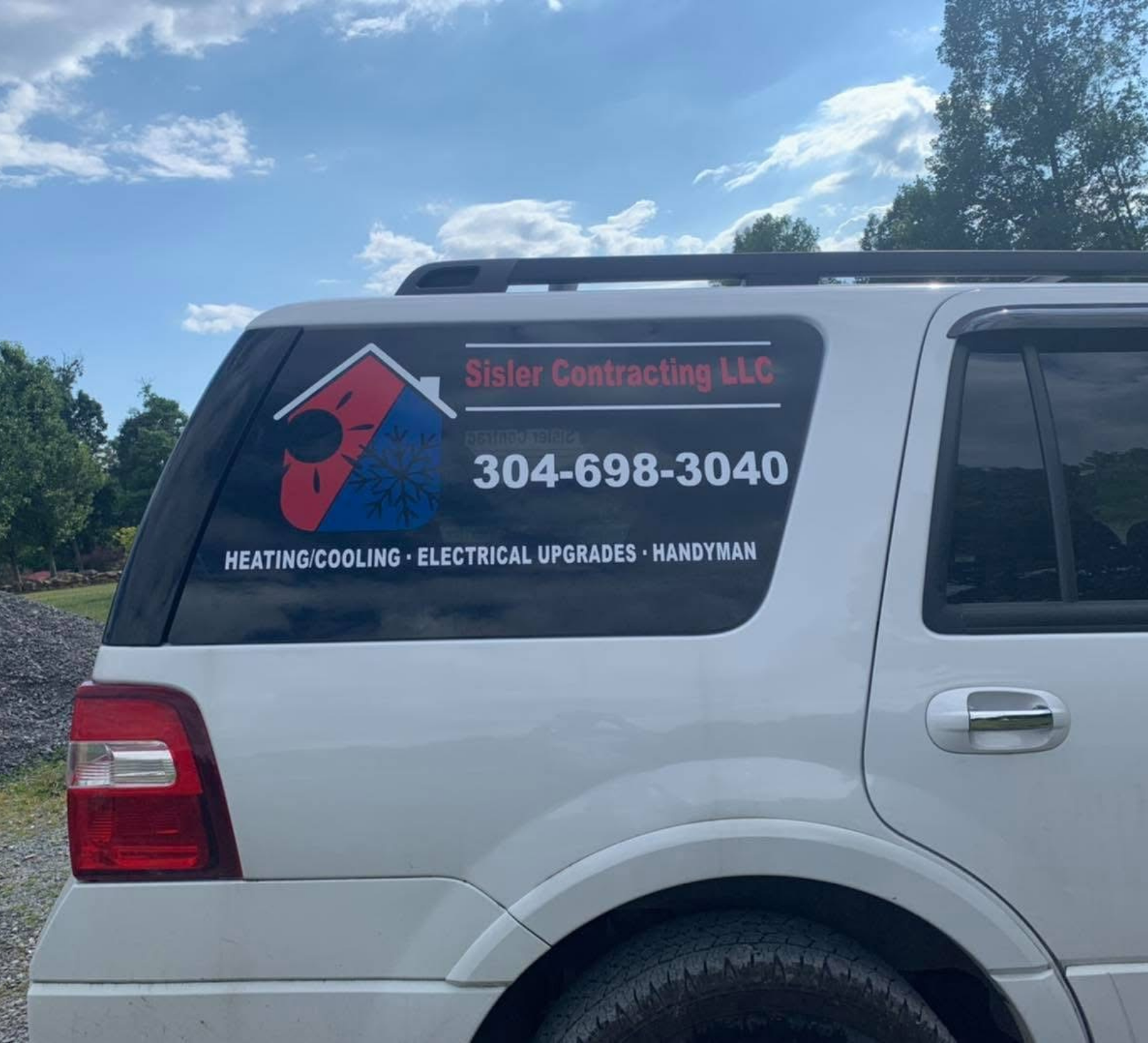 Silver SUV with “Sister Contracting LLC” window decal, phone number, and heating/cooling service text