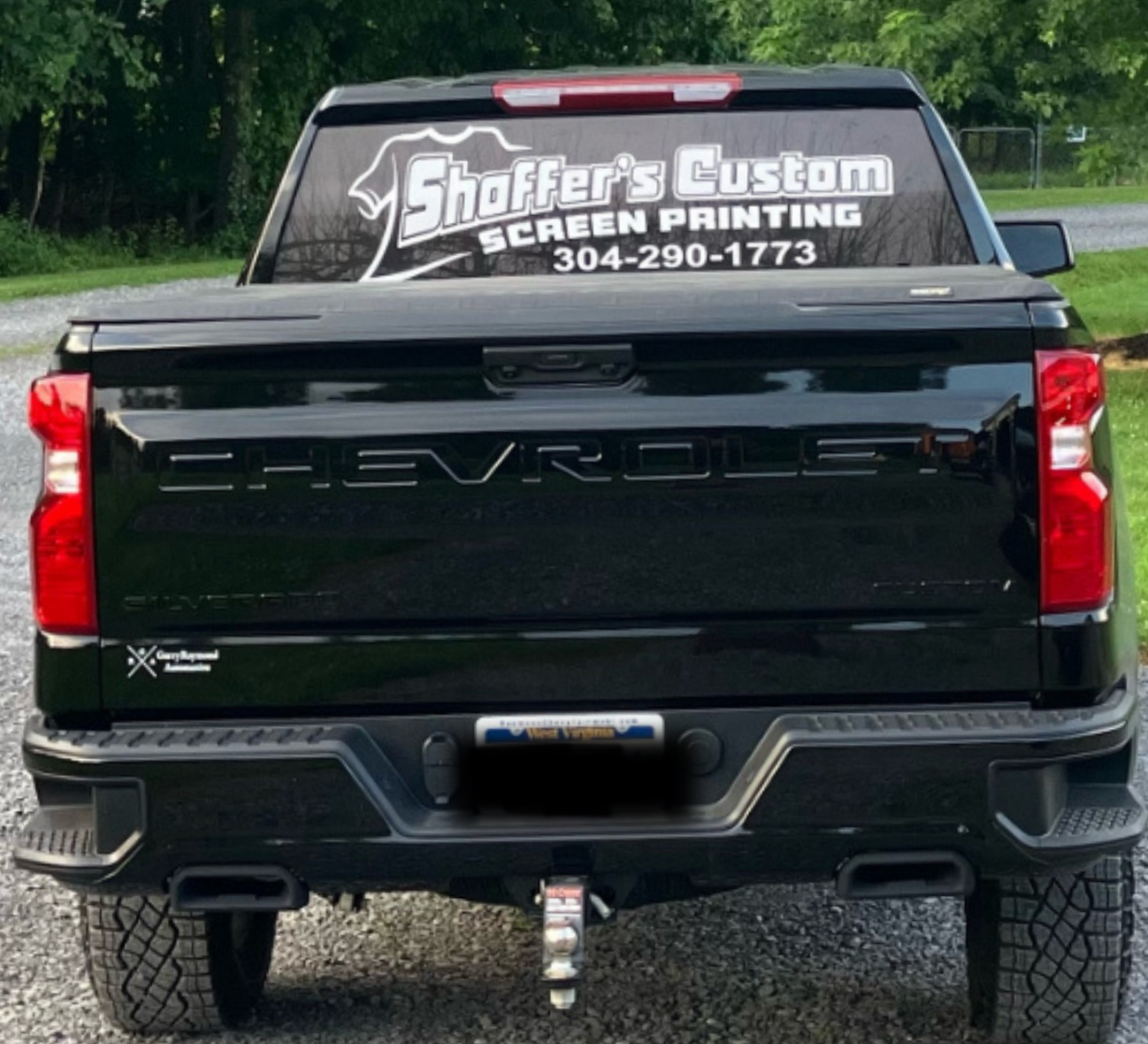 Black Chevrolet pickup tailgate with custom rear window decal for Sifers Custom Screen Printing.