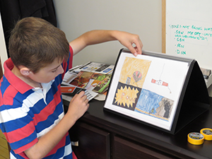 Max displaying comic books.
