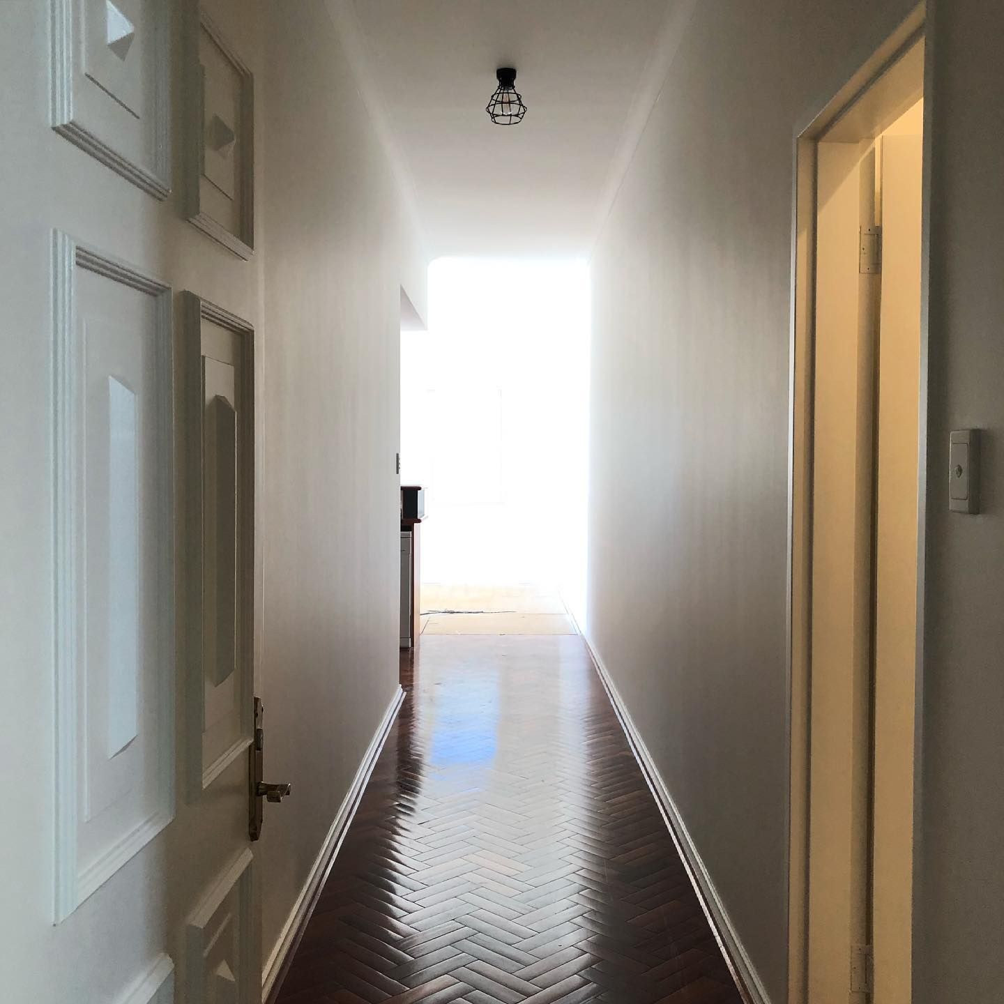 A long hallway with a light on the ceiling