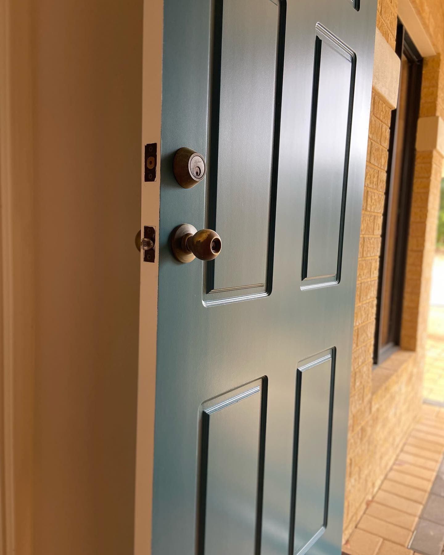 A blue door with a brass knob on it