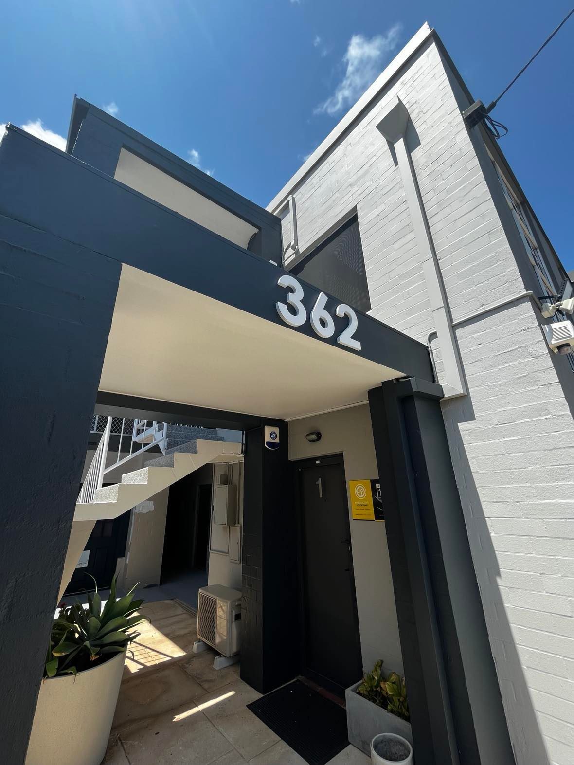 The entrance to a building with the number 362 on it.
