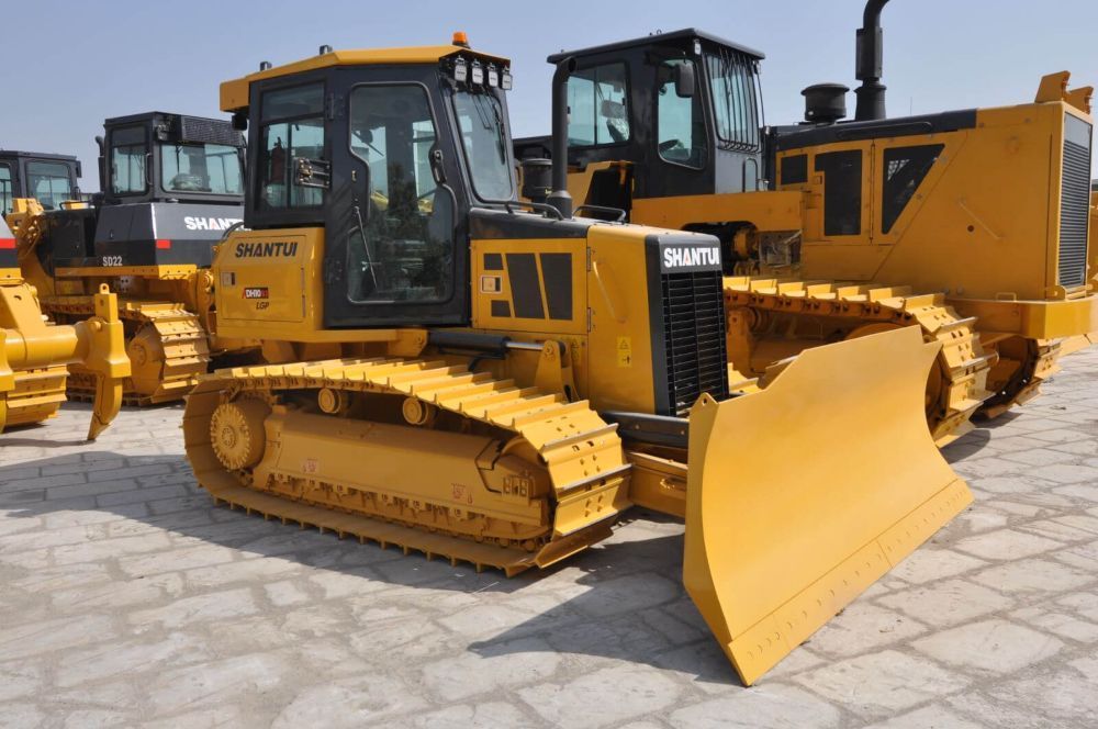 A Yellow Bulldozer is Parked in a Parking Lot — Rowdraulics NQ Pty Ltd in Mount Louisa, QLD