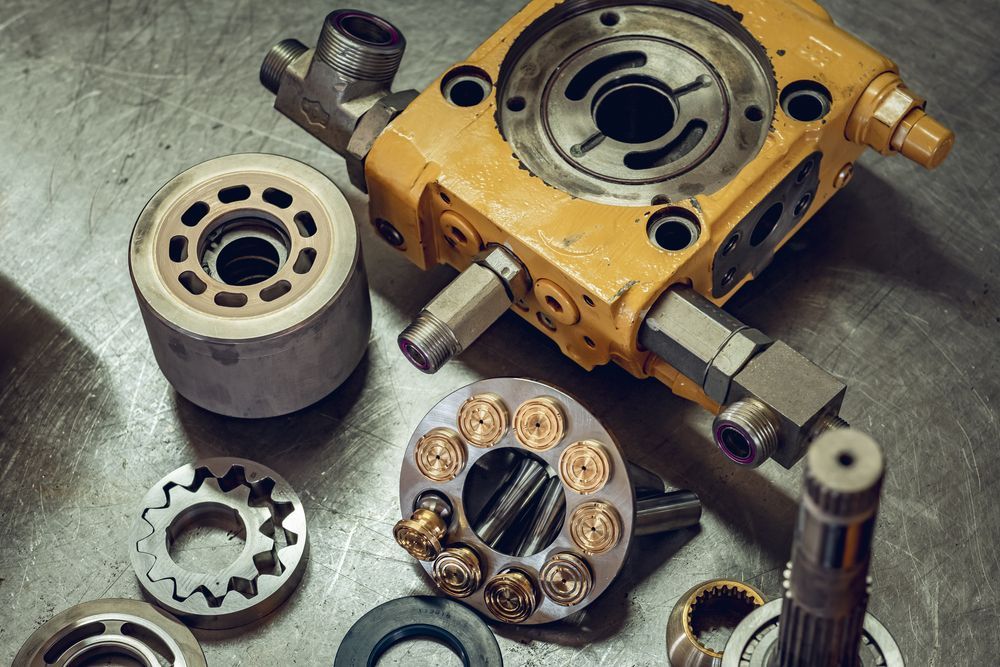 Hydraulic Parts Placed On Table In The Workshop — Rowdraulics NQ Pty Ltd in Moranbah, QLD