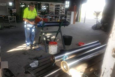 Worker Repairing On Hoist — Rowdraulics NQ Pty Ltd in Mount Louisa, QLD