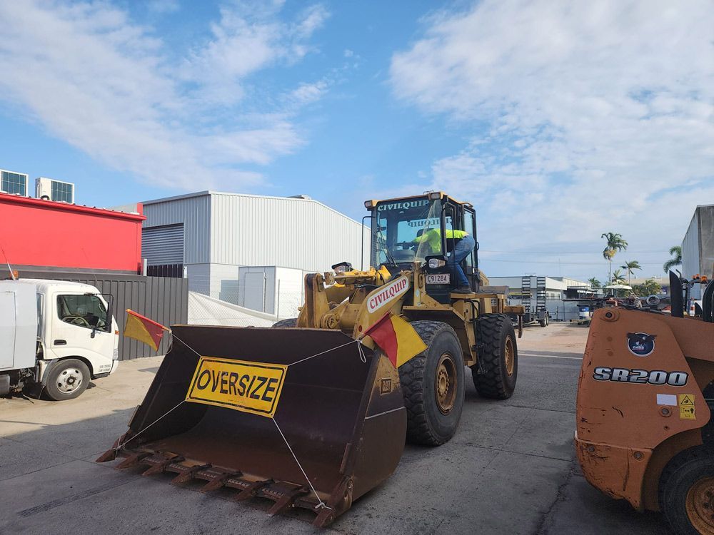 A Bulldozer With a Yellow Sign That Says' Oversized' on It — Rowdraulics NQ Pty Ltd in Mount Louisa, QLD