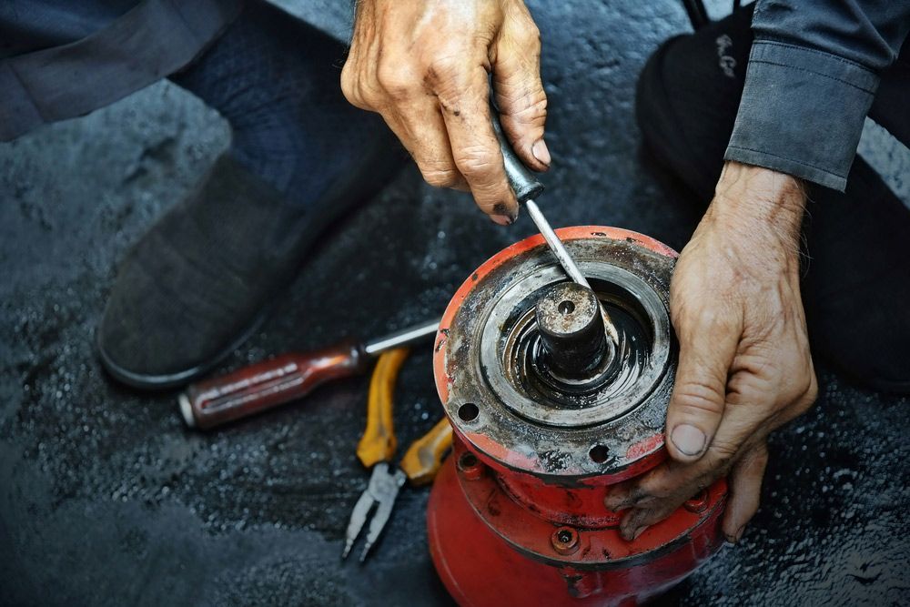 Man Working On Hydraulic Cylinder Engine — Rowdraulics NQ Pty Ltd in Mount Louisa, QLD
