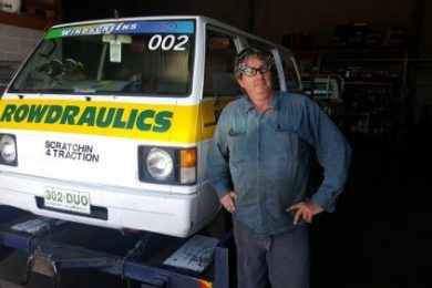 Man Is Standing in Front of A Rowdraulics Truck — Rowdraulics NQ Pty Ltd in Cairns, QLD