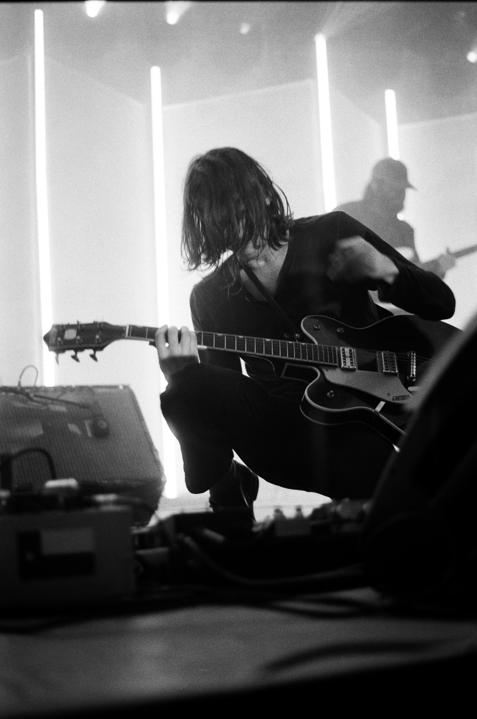 A black and white photo of a man playing a guitar