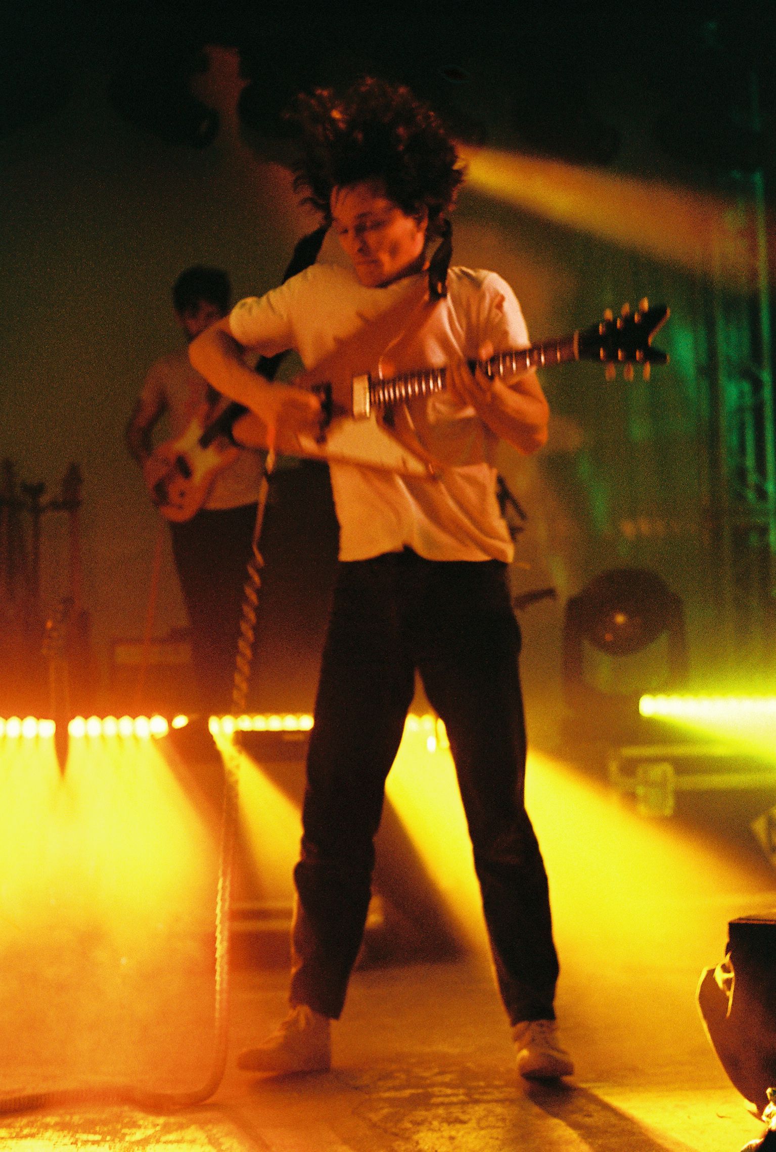 A man is playing a guitar on a stage