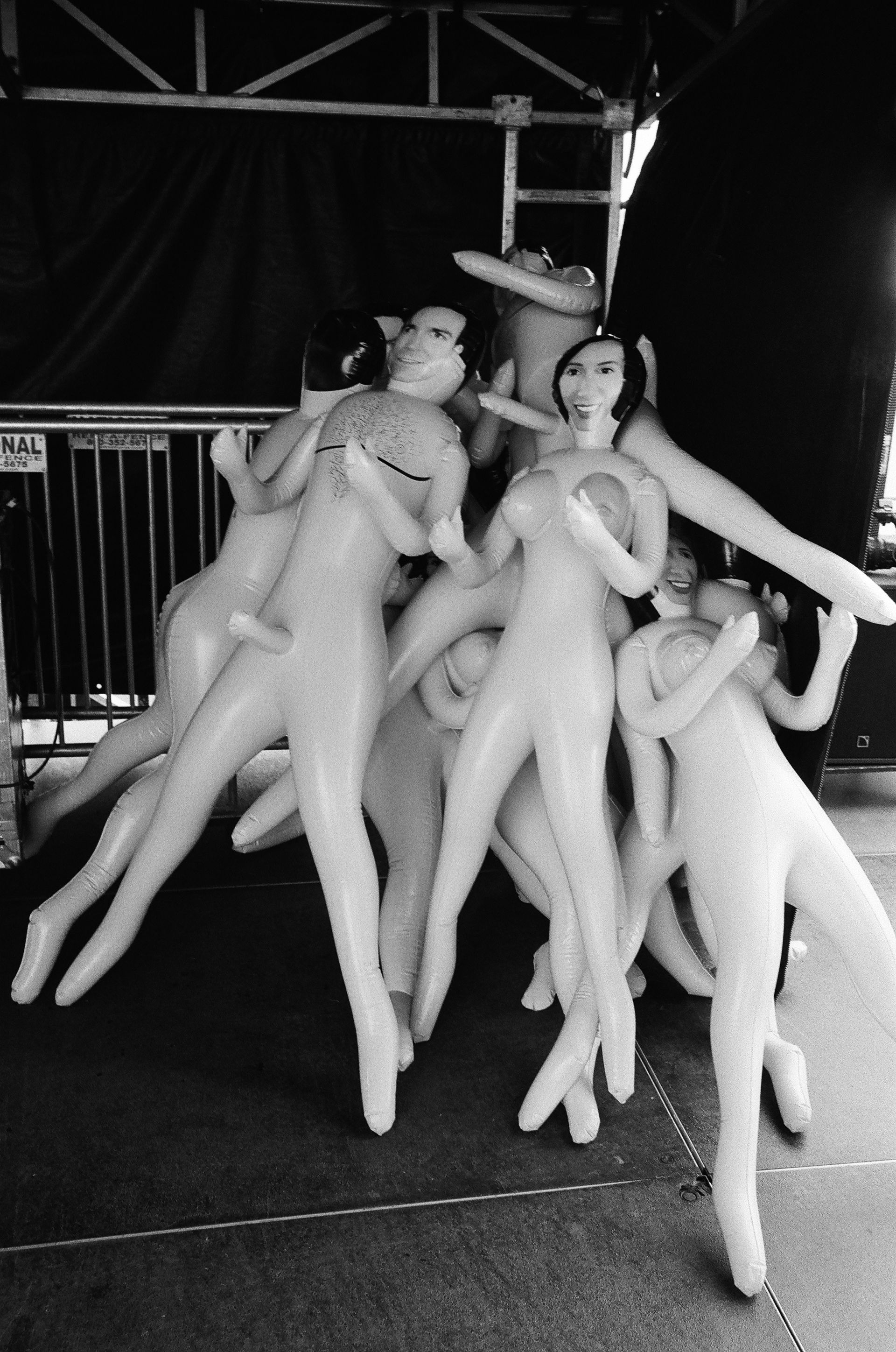 A photo of blow-up dolls piled together at a music festival.