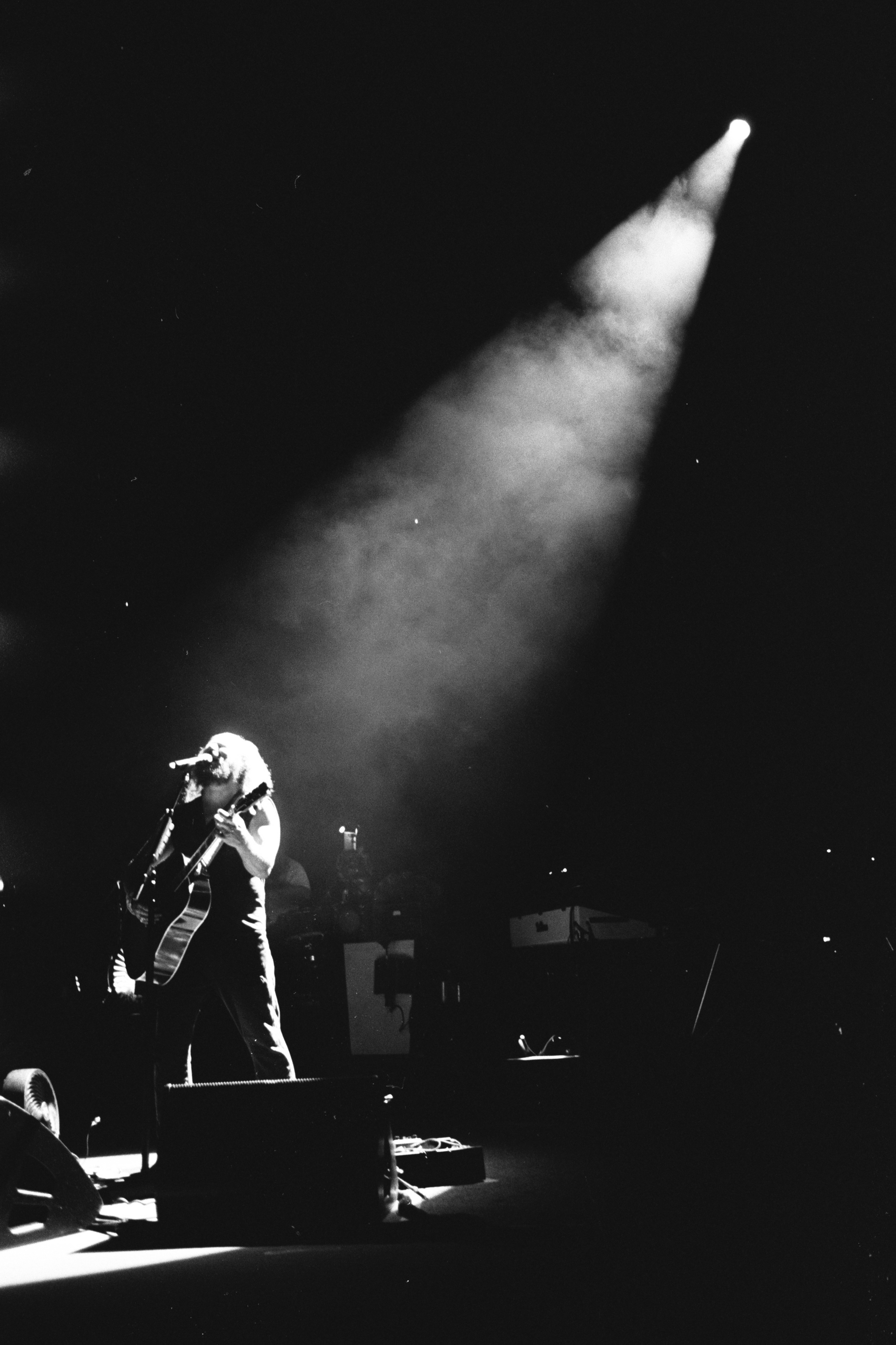 A black and white photo of a person playing a guitar