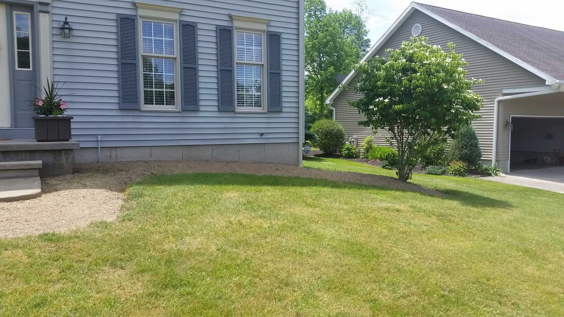 front right side of blue house without landscaping