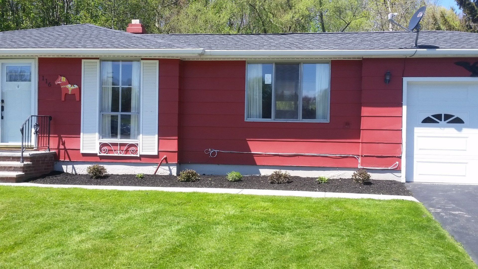 new landscaping in front of red house