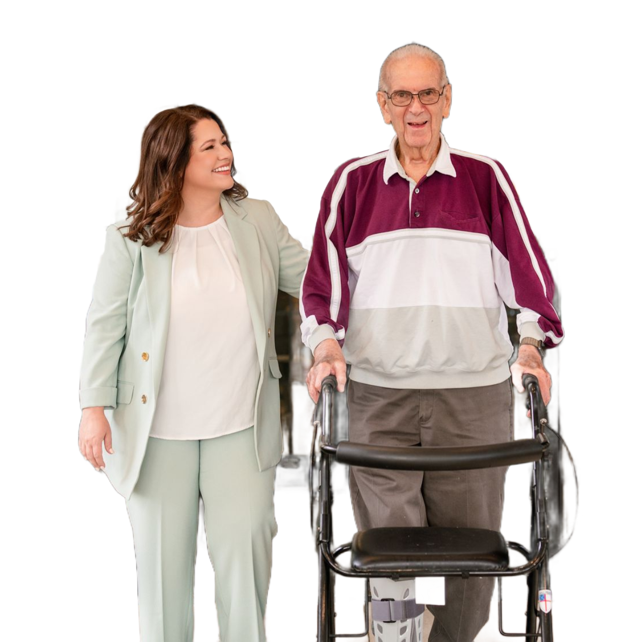 Woman assisting a person using a walker. They walk together smiling.