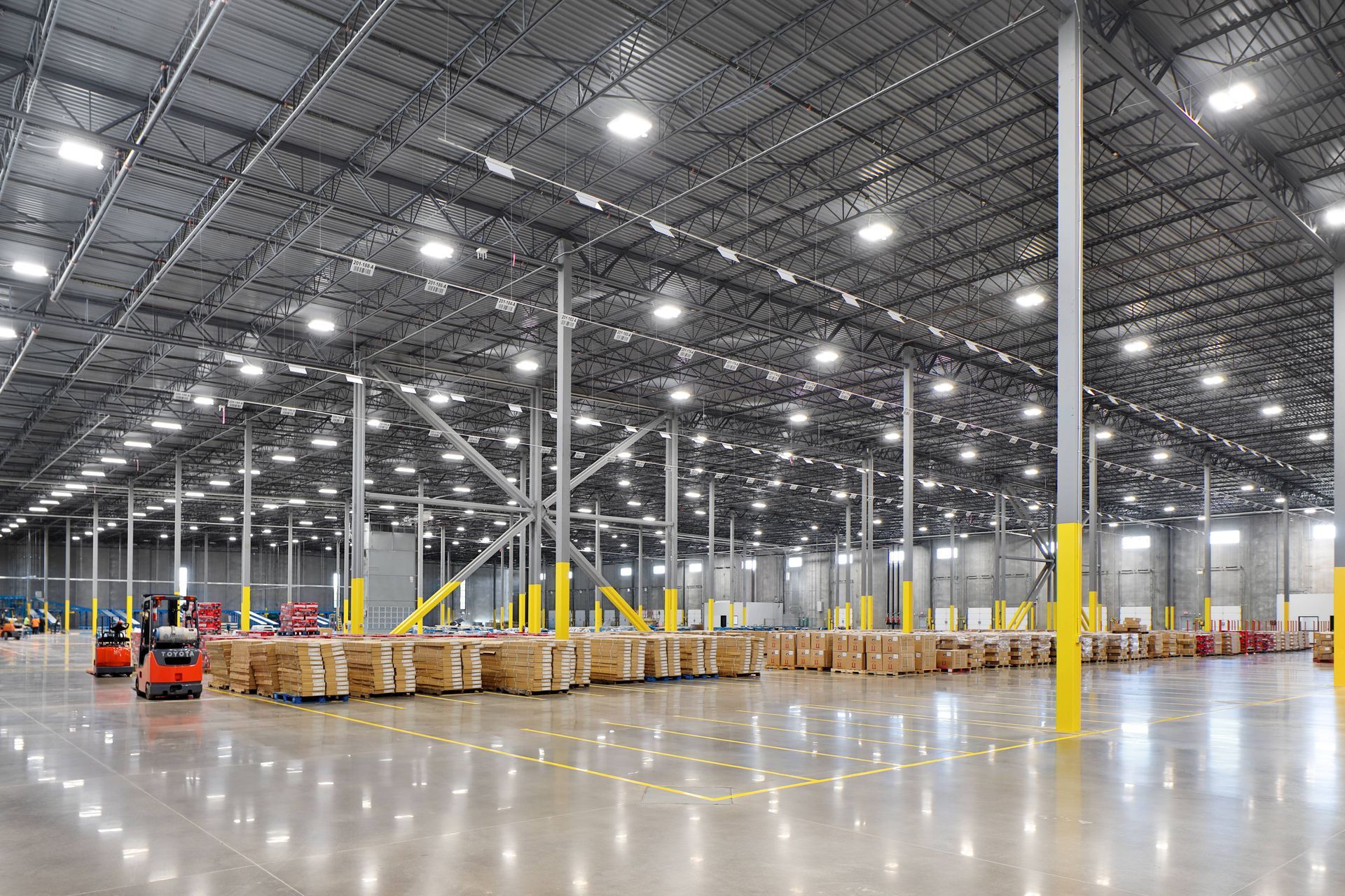 An industrial warehouse with a concrete coating on the floor at Resilient Concrete Coatings near Cyp