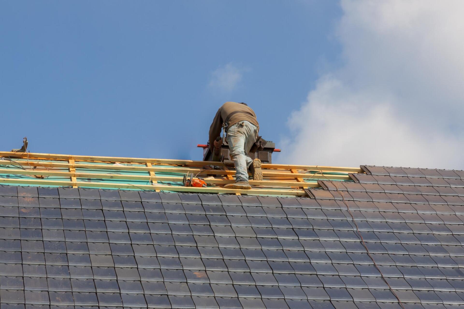 worker checking the roof