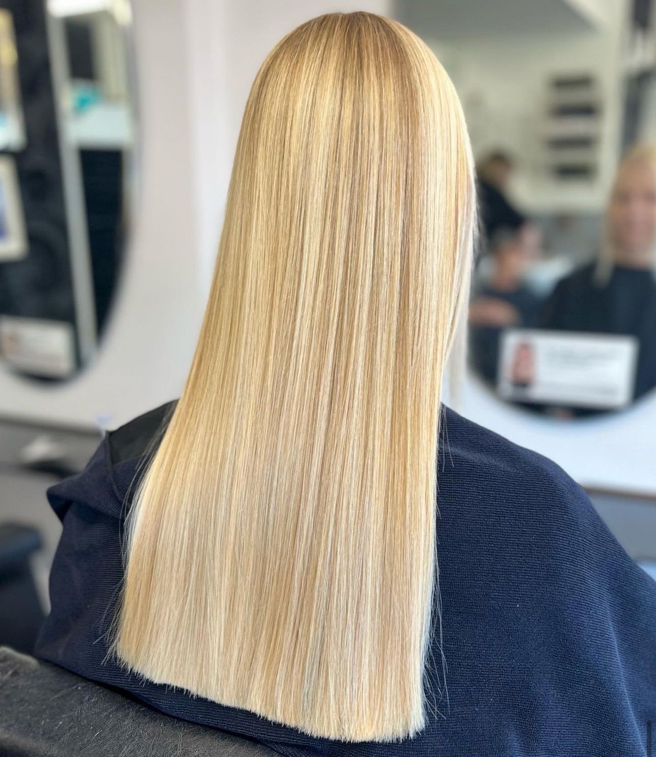 A woman with long blonde hair has had a hair cut at a professional hair salon in toddington