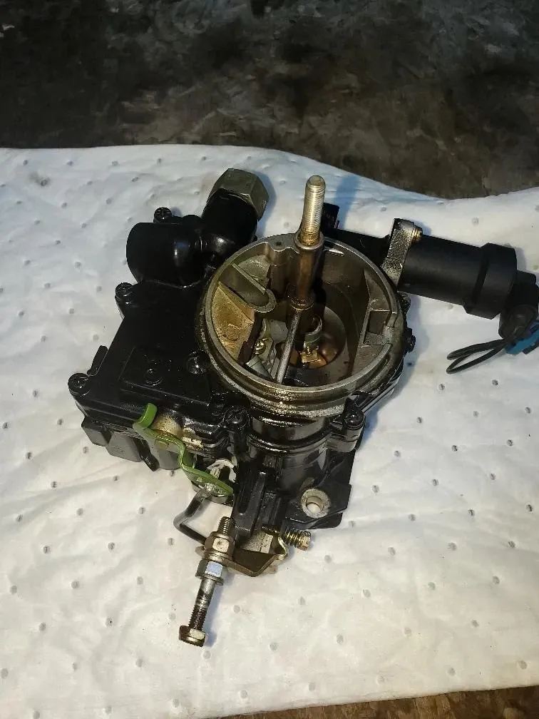 A carburetor is sitting on a piece of paper towel