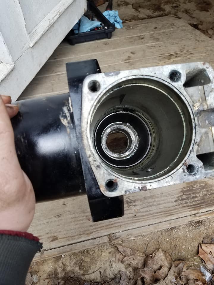 A person is holding a black pipe with a hole in the middle.
