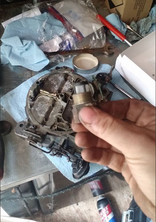 A person is holding a piece of metal in their hand.