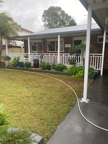 A House With A Lawn And A Hose In A Yard - Aluminium Manufacturer in Newcastle, NSW