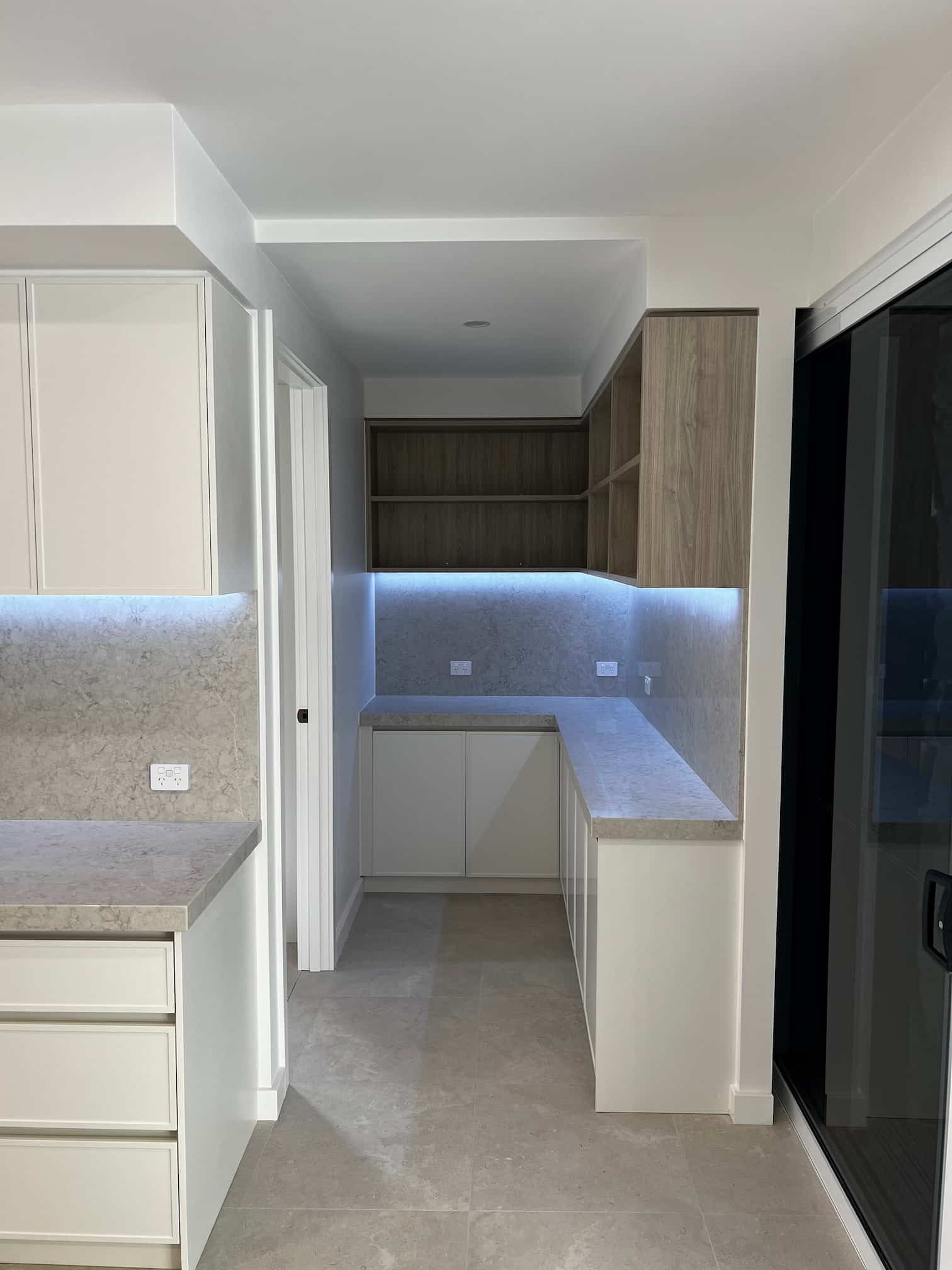 A Kitchen With White Cabinets and a Marble Counter Top — Poljak Plasterers in South Townsville, QLD