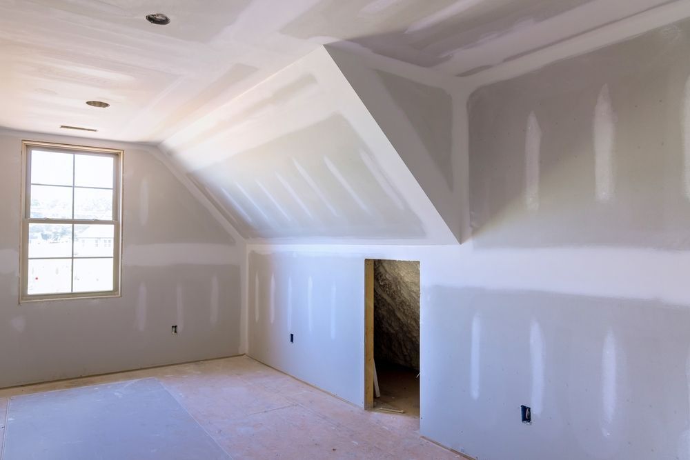 An Empty Room With a Vaulted Ceiling and a Window — Poljak Plasterers in Belgian Gardens, QLD