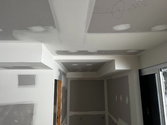 A Hallway With a Ceiling That Has Holes in It — Poljak Plasterers in Douglas, QLD