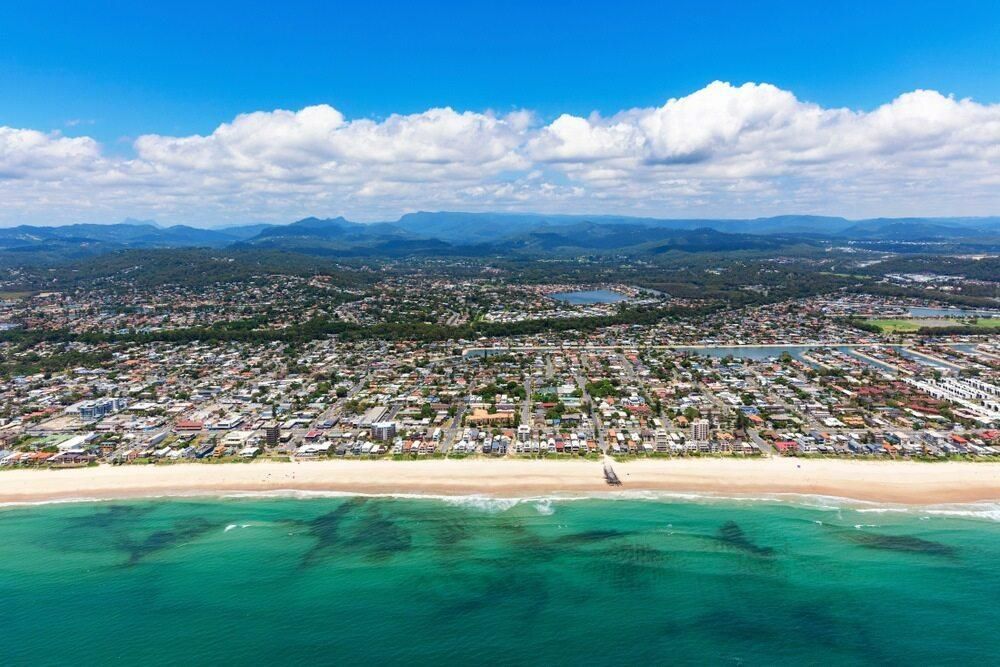 An Aerial View of a Beach With a City in the Background — Poljak Plasterers in Oonoomba, QLD