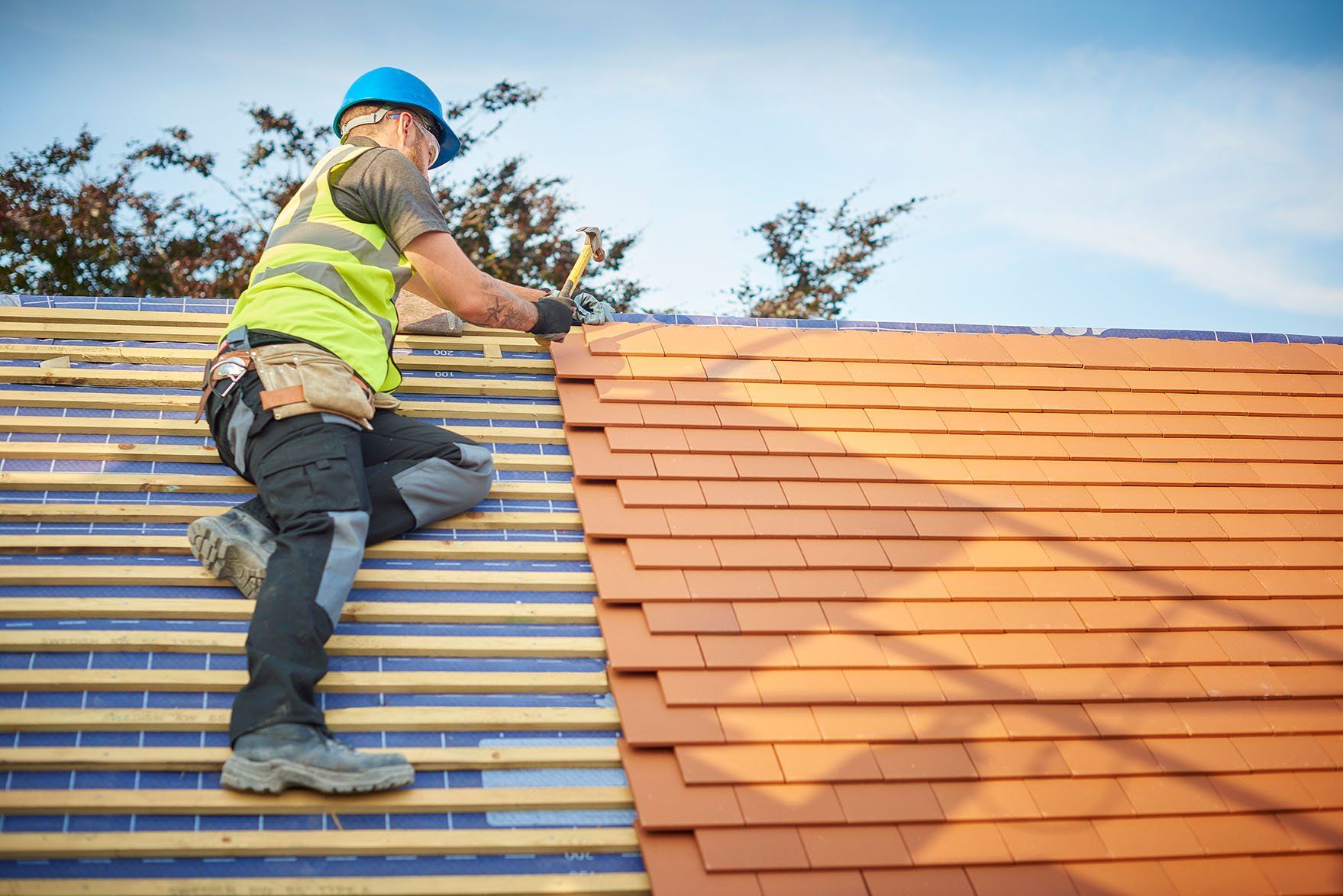 Roofer nails on the roof tiles — Morehead City, NC — F&R Construction Roofer nails on the roof tiles — Morehead City, NC — F&R Construction