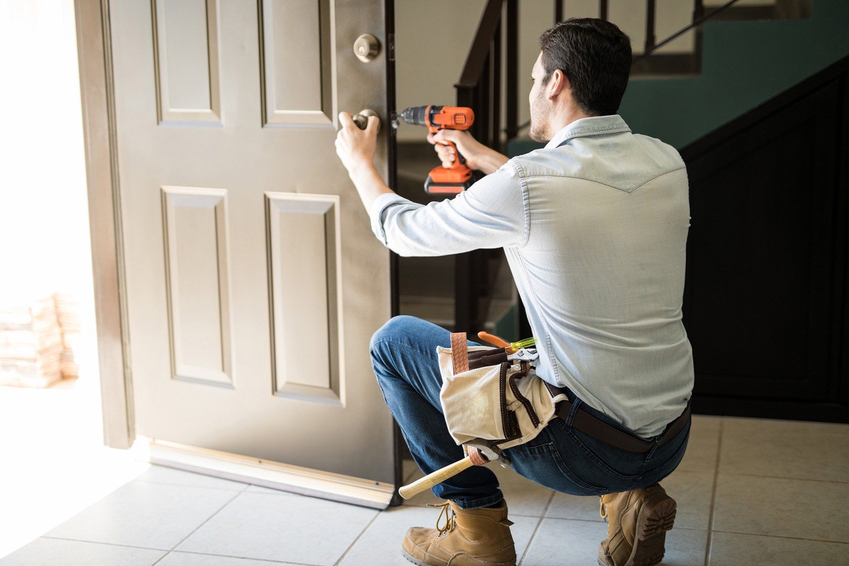 Young man fixing a door — Morehead City, NC — F&R Construction