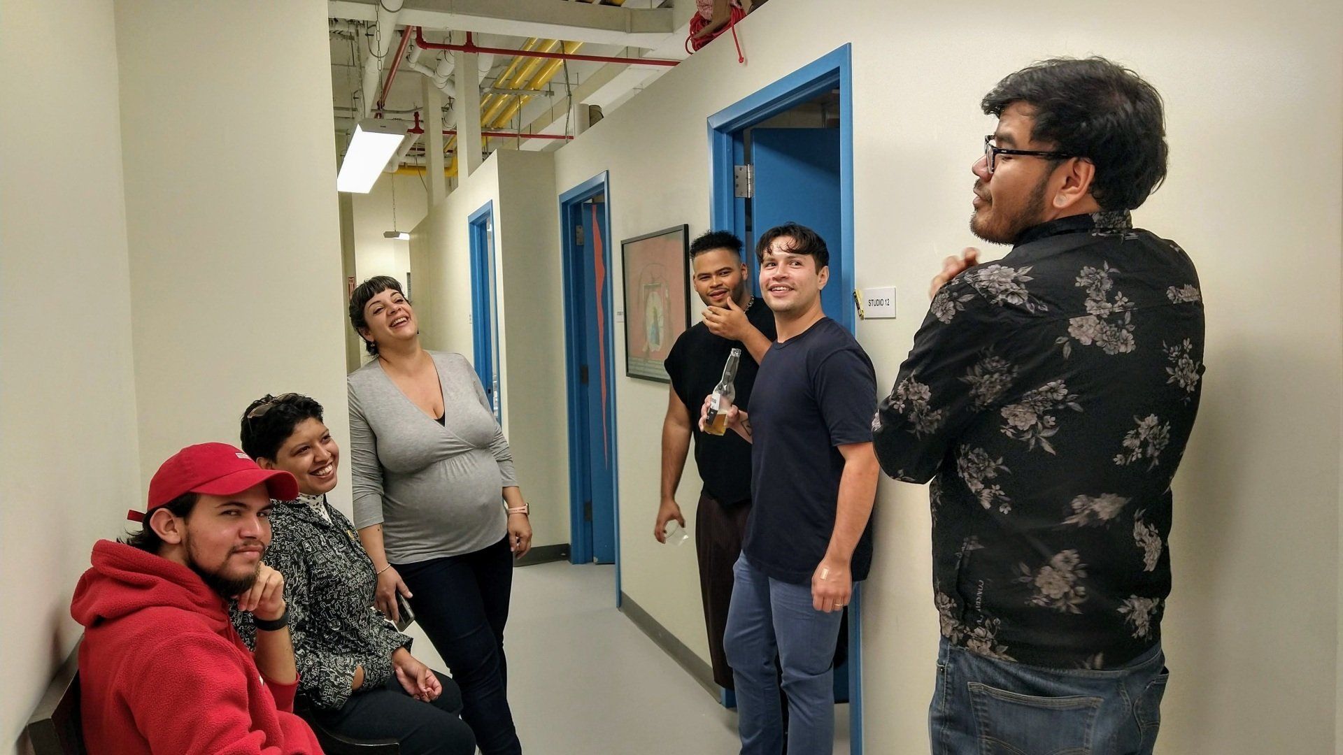 A group of people are standing in a hallway.