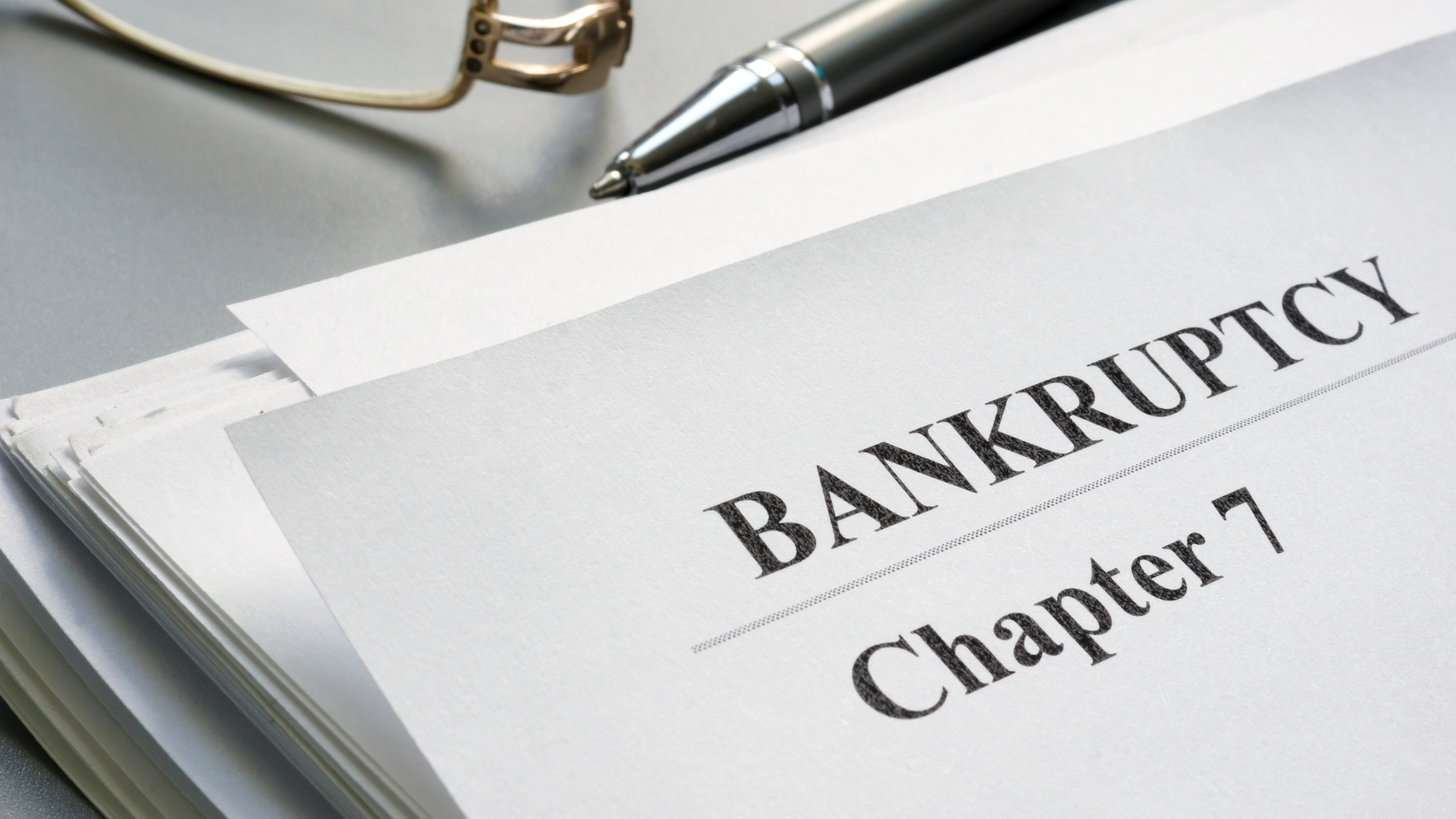 A book is open to a page that says bankruptcy chapter 7