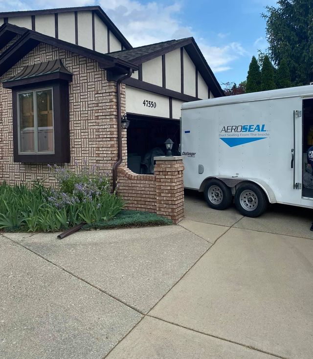 A montreal trailer is parked in front of a house