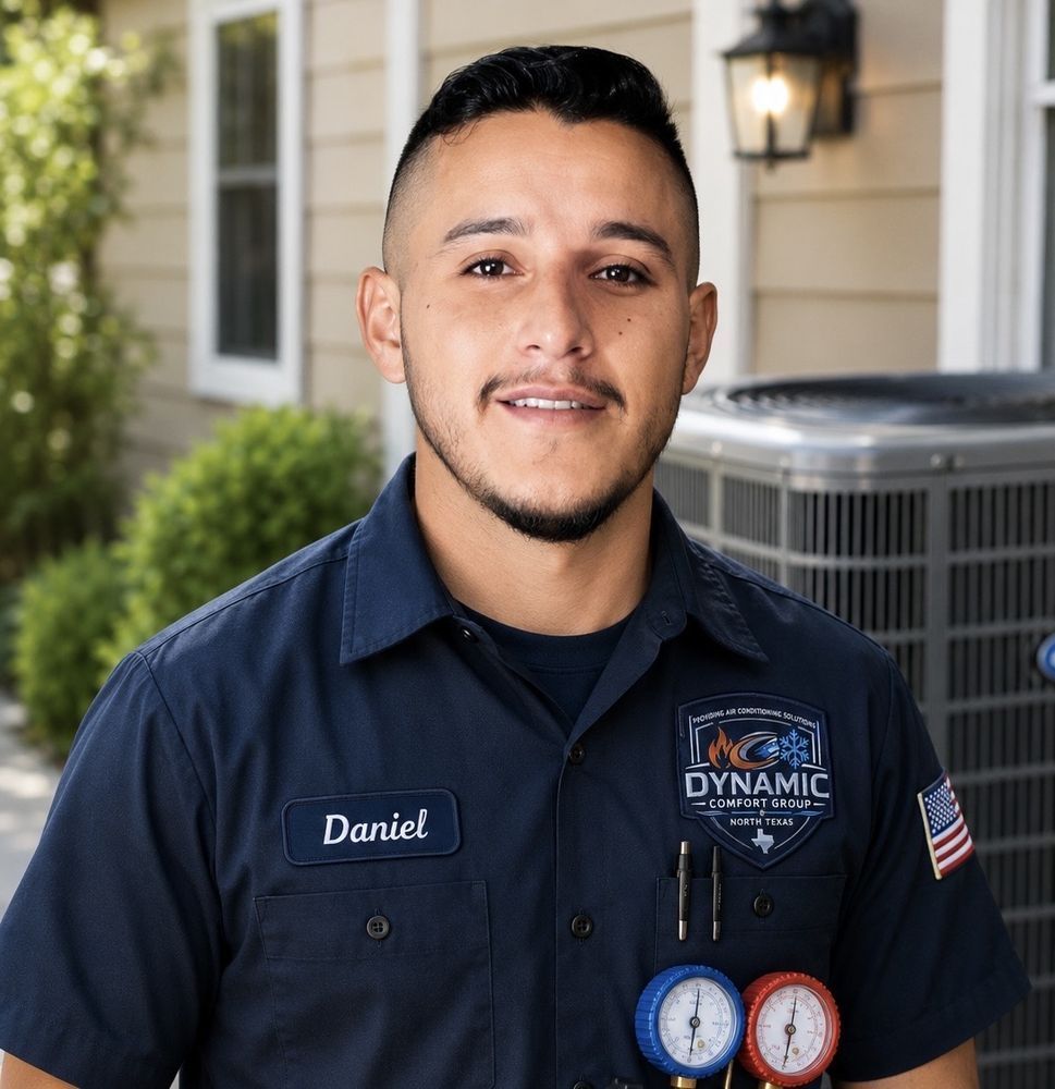 Portrait of a smiling HVAC technician in a navy uniform standing outside a house with service gauges visible.