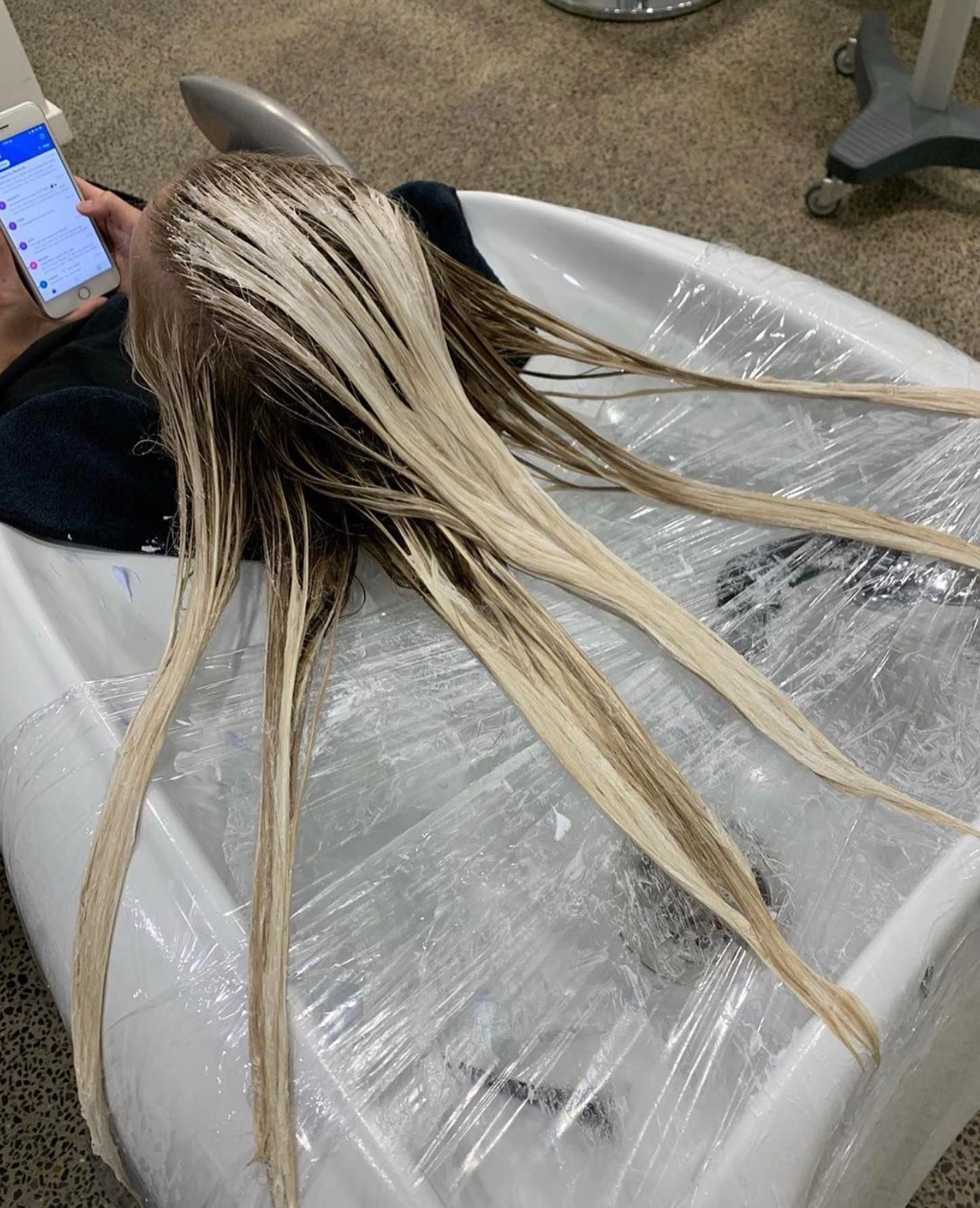 Long blond hair laid on a salon chair covered in plastic wrap — Miilan Hair in Darwin City, NT
