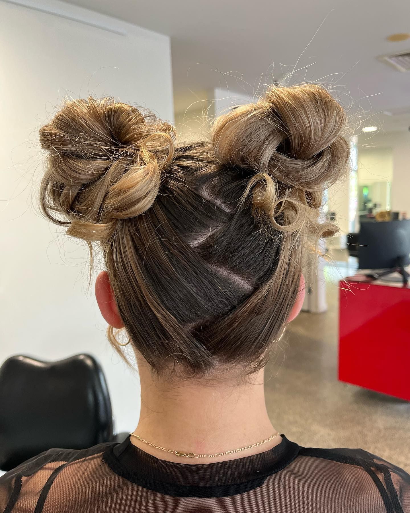 Back View of a Person With Two Space Buns in a Bright Salon Setting — Miilan Hair in Darwin City, NT