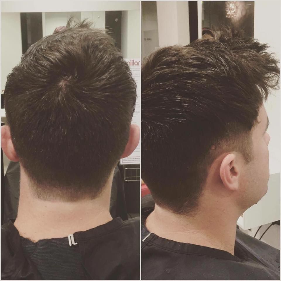 Back and side views of a short dark haircut with faded sides in a salon mirror — Miilan Hair in Darwin City, NT