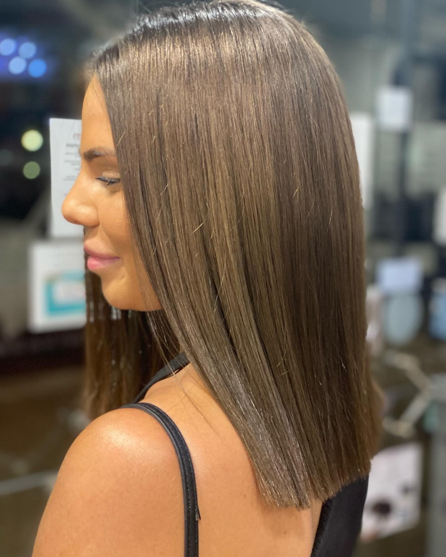 Side Profile of a Woman With Sleek, Straight Brown Hair — Miilan Hair in Darwin City, NT