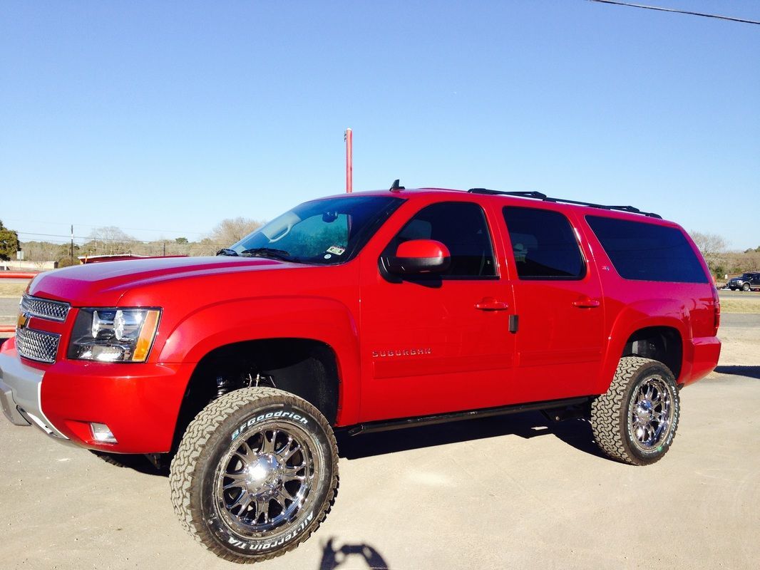 A red suv is parked on the side of the road