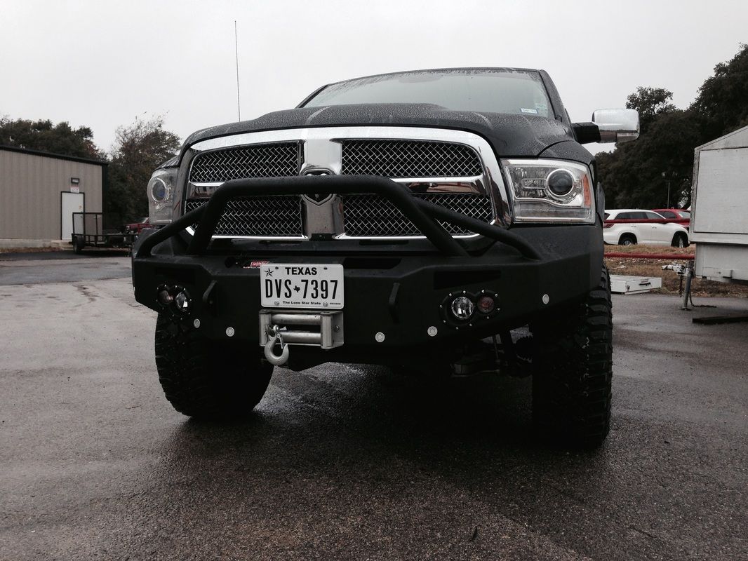 A black truck with a license plate that says ivs-739t is parked in a parking lot.