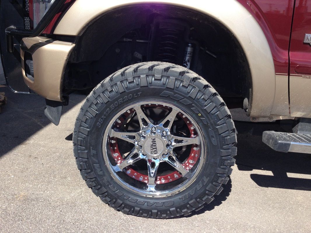 A close up of a tire on a red truck