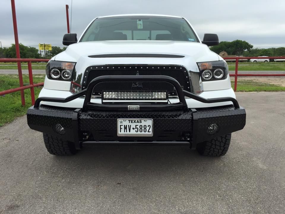 A white truck with a license plate that says fmv-5882
