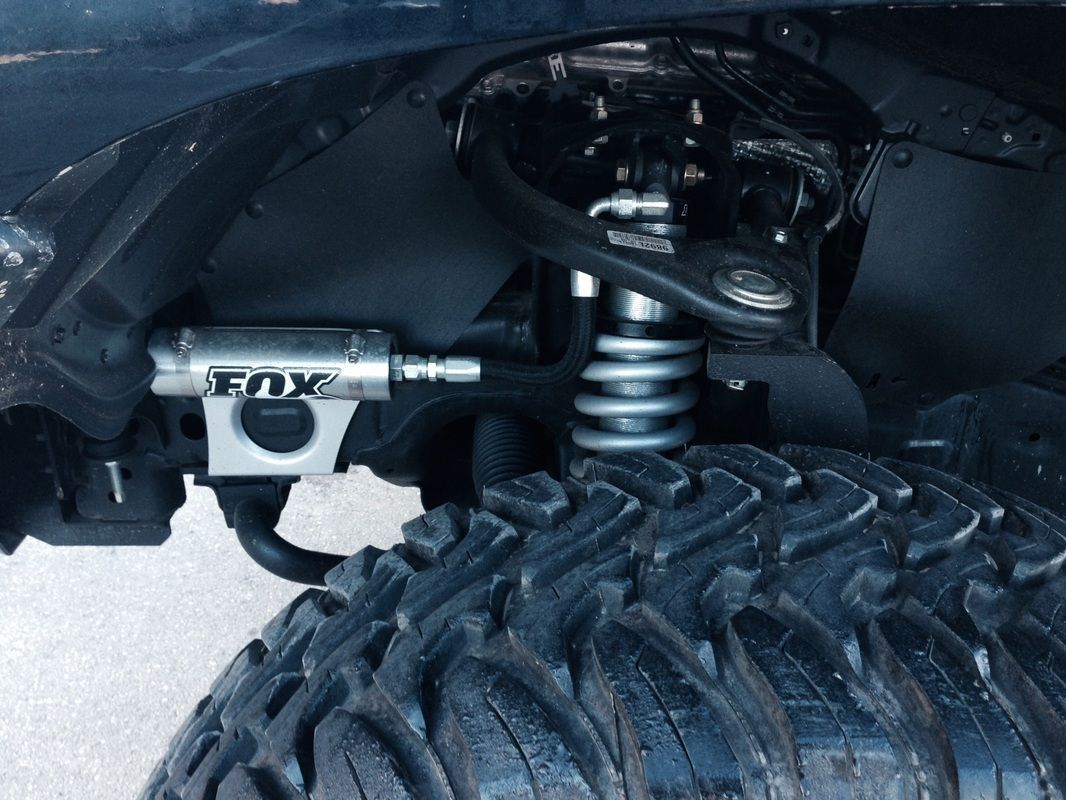 A close up of a fox shock on a tire