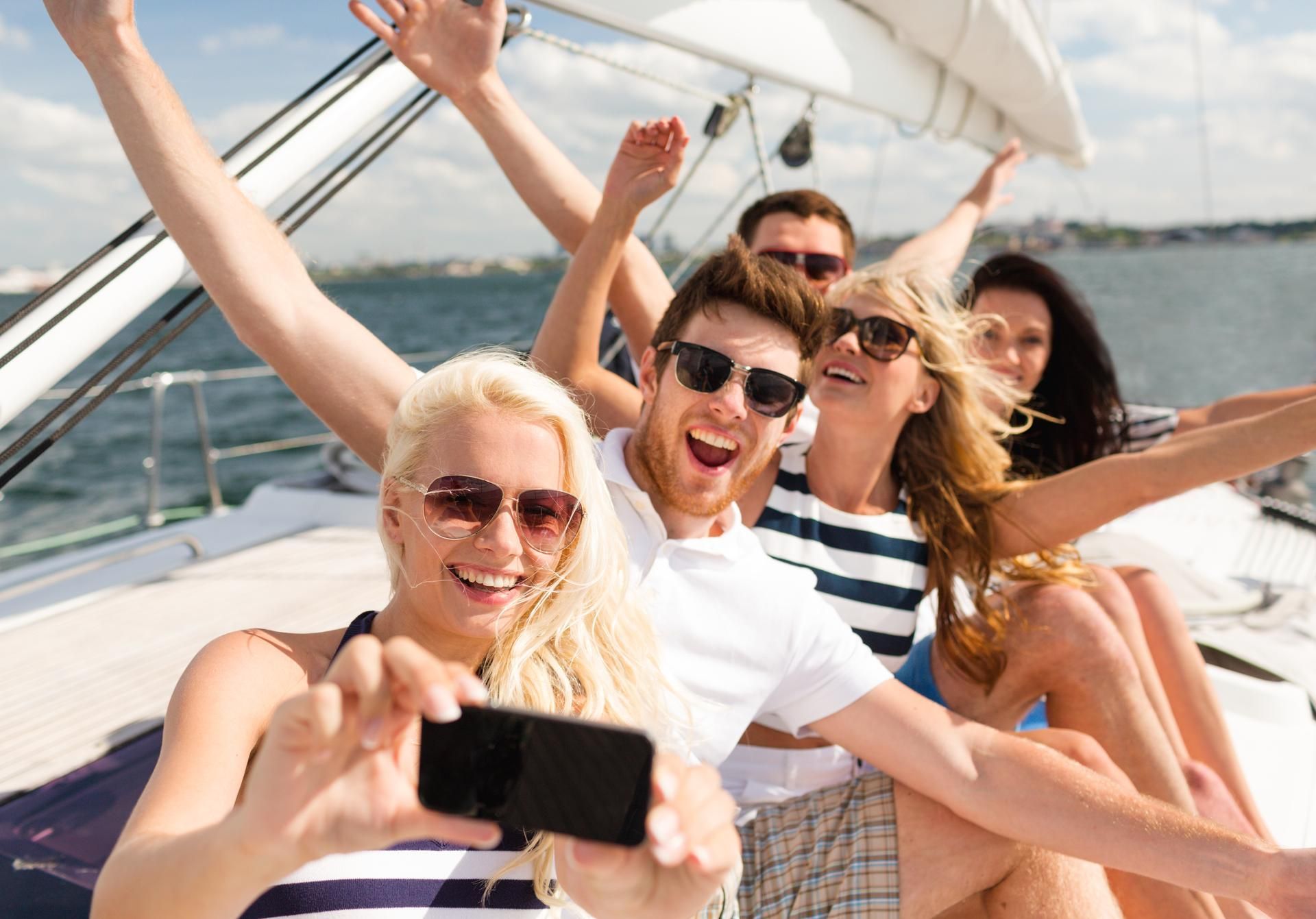 A group of people are taking a selfie on a boat.